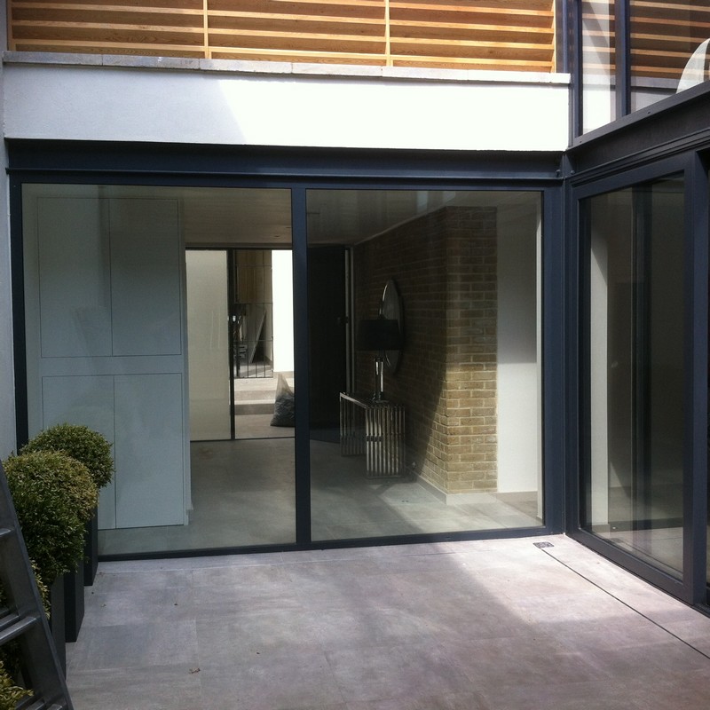 Floor-to-ceiling sliding doors opening to courtyard in Sydenham