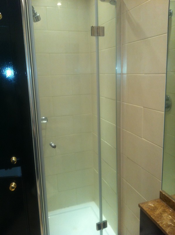 Frameless glass shower enclosure with chrome fittings in Sydenham