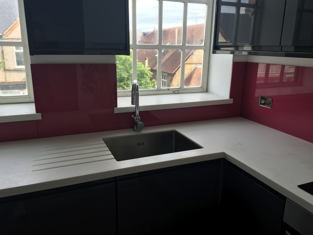 Deep plum coloured glass splashback in modern Sydenham kitchen
